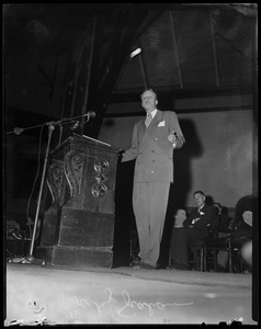 Billy Graham on stage, addressing the crowd