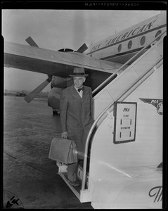 Dr. Paul Dudley White boarding Pan American flight with luggage