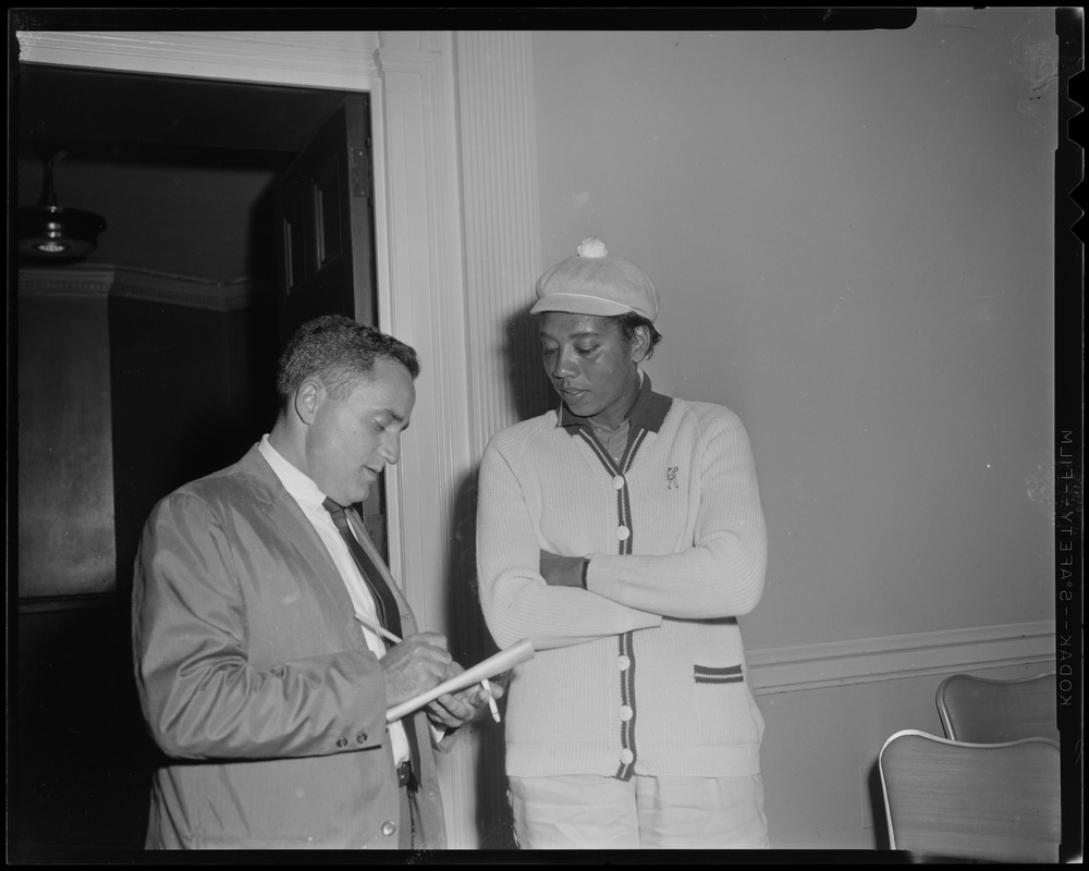 That Gibson girl - Althea Gibson and Record sports reporter Milton Greenglass during a press conference at the Hotel Statler. Althea is competing in a golf tournament at Ponkapoag Golf Course in Canton