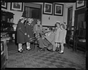 Cliff Barrows playing a trombone for five children