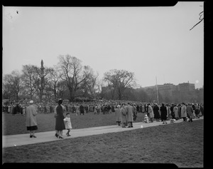 View of large crowd standing in Boston Common for Billy Graham event with Soldiers and Sailors Monument visible
