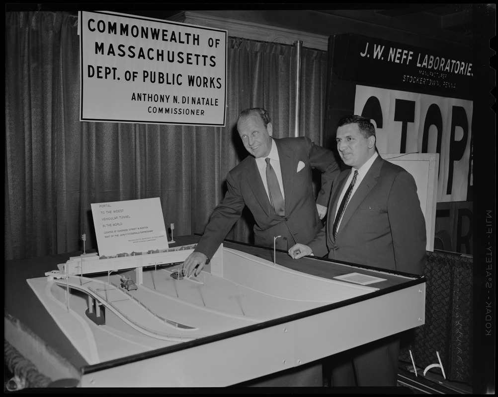 William Randolph Hearst, Jr. and other man standing next to Massachusetts Department of Public Works display entitled "Portal to the widest vehicular tunnel in the world located at Congress Street in Boston, part of the John F. Fitzgerald Expressway"