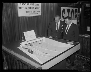 William Randolph Hearst, Jr. and other man standing next to Massachusetts Department of Public Works display entitled "Portal to the widest vehicular tunnel in the world located at Congress Street in Boston, part of the John F. Fitzgerald Expressway"