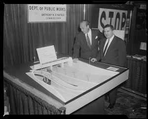 William Randolph Hearst, Jr. and other man standing next to Massachusetts Department of Public Works display entitled "Portal to the widest vehicular tunnel in the world located at Congress Street in Boston, part of the John F. Fitzgerald Expressway"