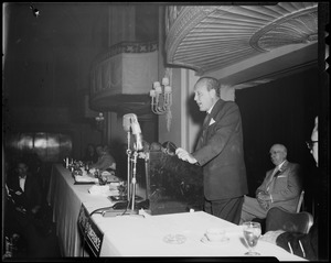 William Randolph Hearst, Jr. speaking at podium for the 38th Mass. Safety Conference, with Mass. Safety Council president Charles L. O'Reilly behind him