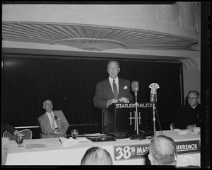 William Randolph Hearst, Jr. speaking at podium with Mass. Safety Council president Charles L. O'Reilly seated to left and Msgr. Timothy F. O'Leary to right.