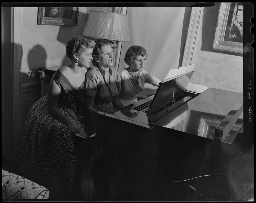 Ryah Tumarkin Goodman seated at piano with her daughters