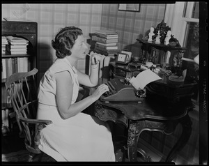 Ryah Tumarkin Goodman seated at desk, using a typewriter