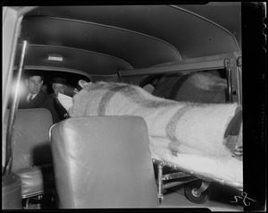 Princess Marie, wrapped in a blanket, being transported on a stretcher