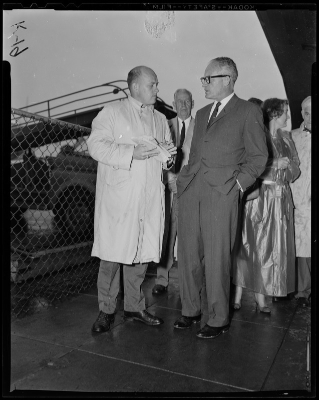 Sen. Barry Goldwater with hands in pockets, talking to another man