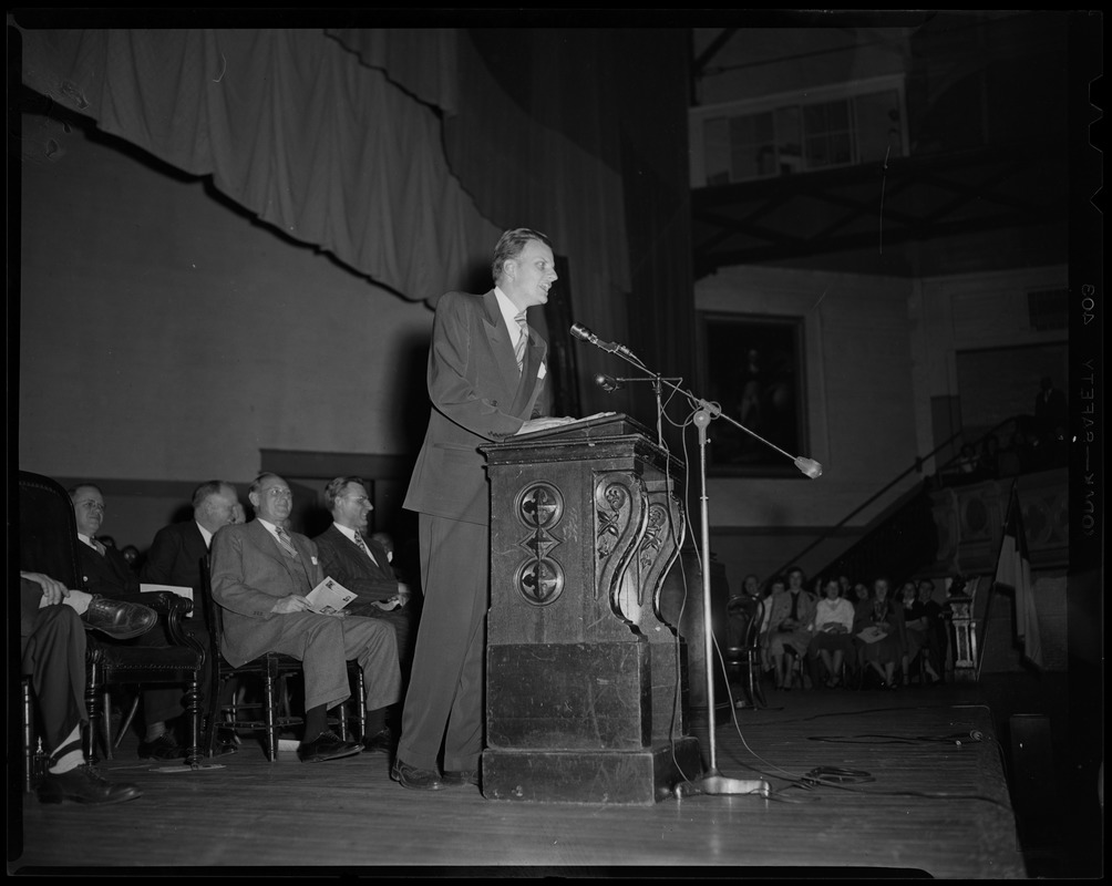 Billy Graham at podium, addressing the crowd