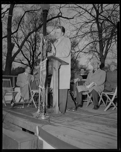 Billy Graham at outdoor podium, wearing overcoat