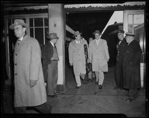 Billy Graham and Cliff Barrows exiting train platform with others