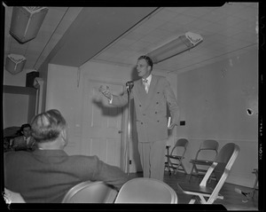 Billy Graham at microphone, addressing a room