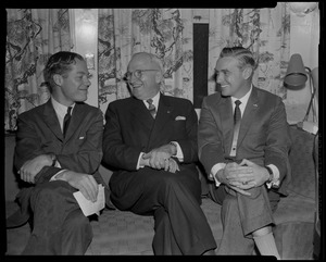 Harry Truman, center, seated on couch and smiling with Edward McCormack, right, and other man