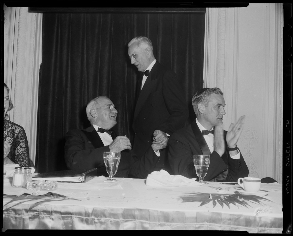 Harry Truman, seated next to Edward McCormack, shaking hands with John W. McCormack