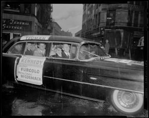 Harry Truman, John F. Kennedy, Foster Furcolo, and Edward McCormack seated in car with their names on the hood and side