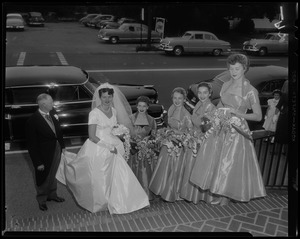 Jerrine Soper outside church with bridesmaids and man holding train of her wedding gown