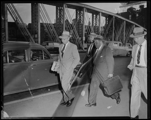 Men in suits and hats walking along bridge, most likely related to Elmer "Trigger" Burke case