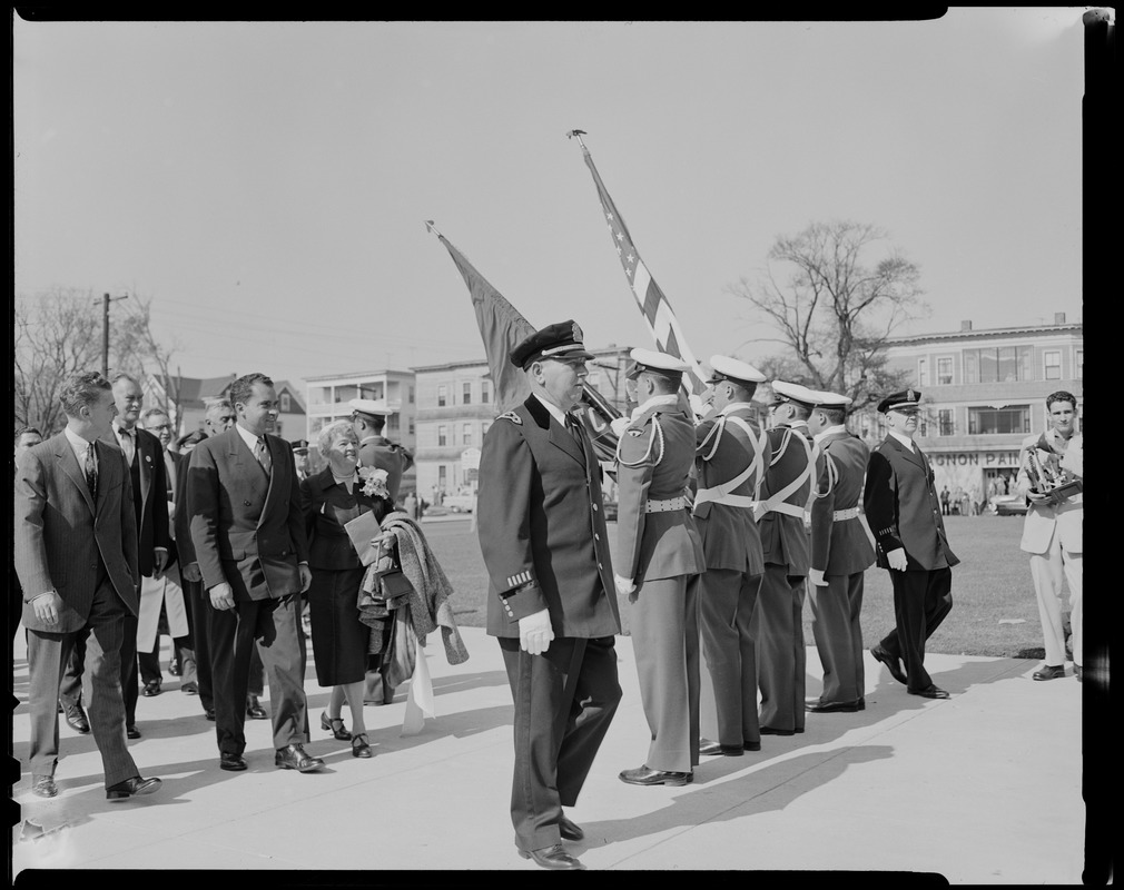 Vice President Richard Nixon walking with Congresswoman Edith N. Rogers toward color guard, students at the Lowell Tech Institute, where Nixon received honorary degree