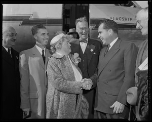 Vice President Richard Nixon shaking hands with U.S. Representative Edith N. Rogers in front of plane with Governor Chris Herter and others looking on