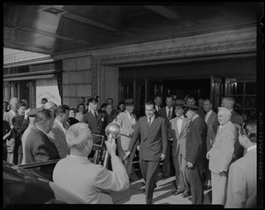 Vice President Richard Nixon exiting the Hotel Statler, on his way to a vehicle