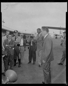 Vice President Richard Nixon at Logan Airport with police officer and photographers