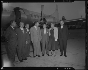 Richard Nixon with five men and a woman outside airplane