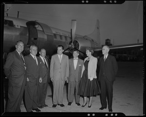 Richard Nixon with five men and a woman outside airplane
