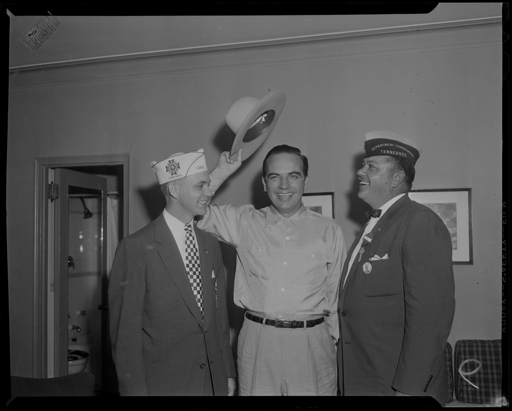 Tennessee Governor Frank Clement waving hat, with two men on either side of him