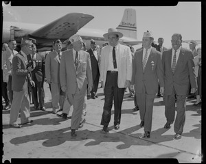 Tennessee Governor Frank Clement, VFW Commander Merton Tice and others look on, and group of men walking away from United airplane