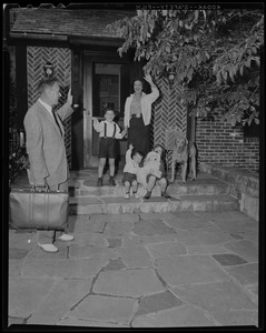 Curt Gowdy waves to his wife Jerre, three children (Cheryl Ann, Curtis Jr., and Trevor), and two dogs on front steps of home