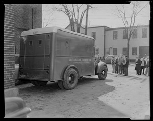 View of armored car with people in background