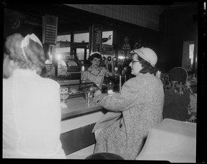 Server Anita Savoie working behind diner counter with seated customers