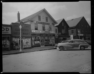 Cars parked outside of Ropes Drug Company store and Danvers Meat Market