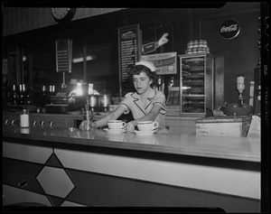 Server Anita Savoie working behind counter at diner