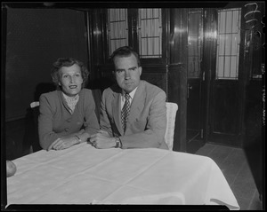 Richard and Pat Nixon seated together at table
