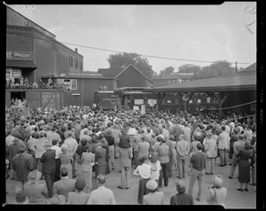 Crowd listening to a person speak on the back of a train during vice presidential candidate Richard Nixon's New England tour