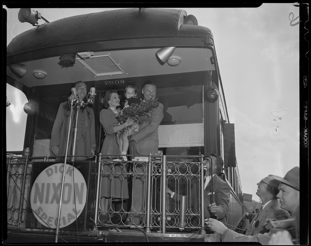 Congressman Christian A. Herter, Pat Nixon, and Senator Henry Cabot Lodge, Jr. with little girl and bouquet on back of train