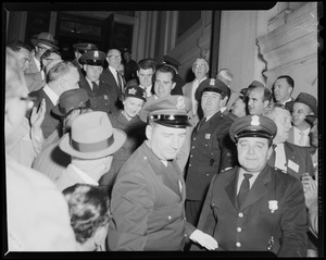 Richard and Pat Nixon surrounded by police officers