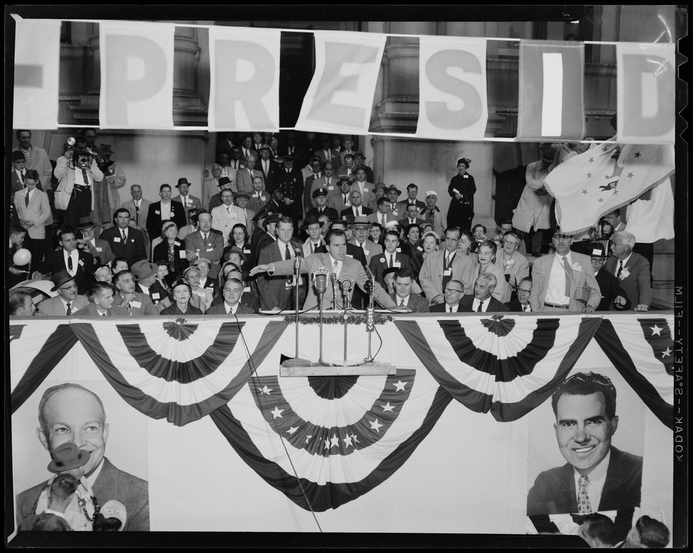 Vice President Richard Nixon speaking at podium with crowd behind him