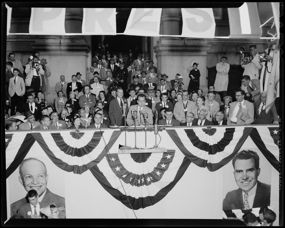 Vice President Richard Nixon speaking at podium with crowd behind him