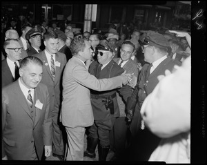 Vice President Richard Nixon shaking hand of someone in crowd