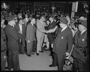 Vice President Richard Nixon shaking hand of someone in crowd