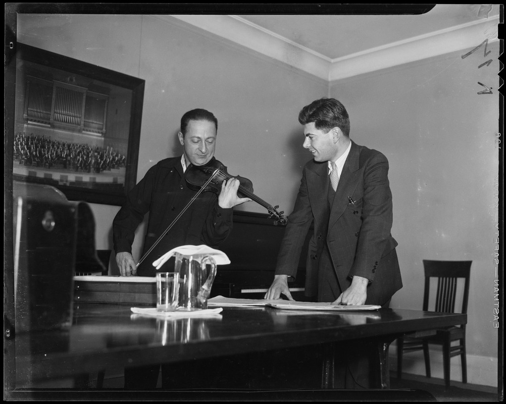Jascha Heifetz showing a student, Raphael Silverman, how he would finger a difficult bar of music