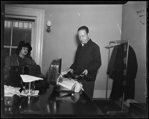 Jascha Heifetz putting away his $50,000 violin which he just used at the rehearsal