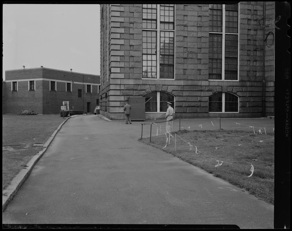 Two men outside of Charles Street Jail building