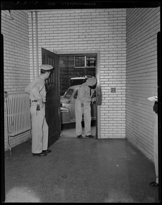 Two prison guards examining lock and door