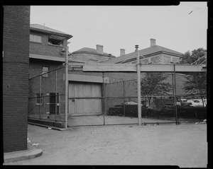 Fenced-off entrance at Charles Street Jail with guard