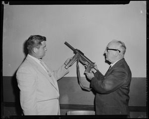 Two men examining gun